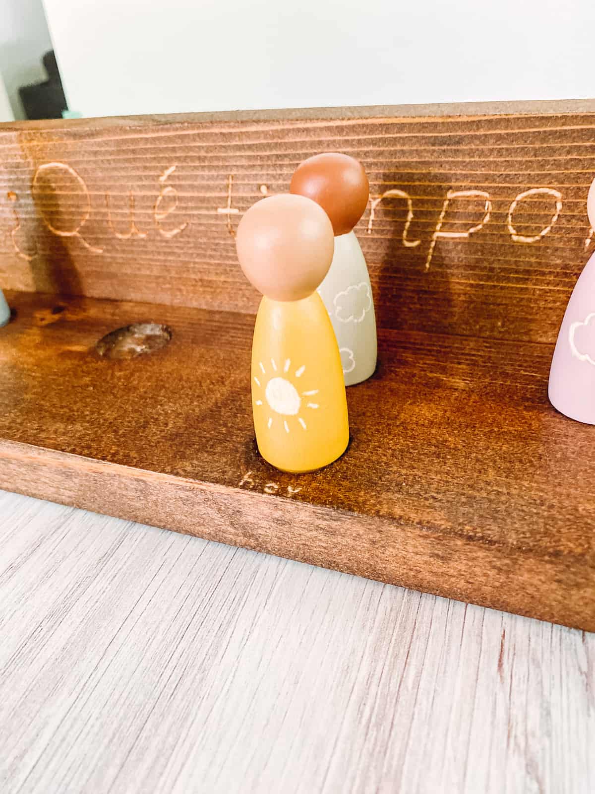 Wooden peg dolls engraved with weather symbols - teaching weather in Spanish