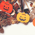 Halloween pumpkins with leaves and pine cones