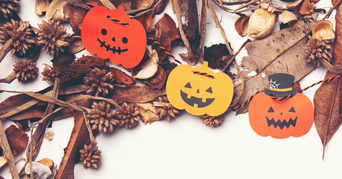 Halloween pumpkins with leaves and pine cones