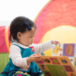 bilingual baby reading a board book