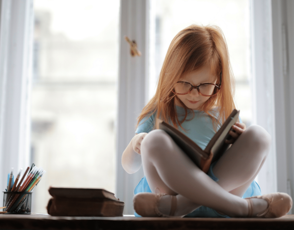 picture of young girl reading a book learning Spanish
